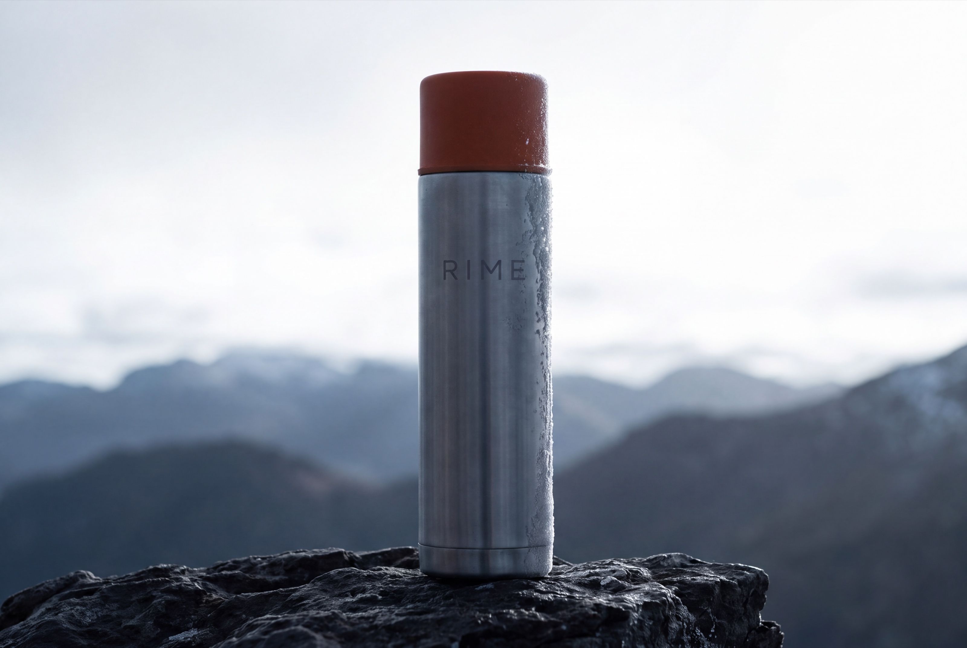 The flask in bright high-key snow light, compressed perspective