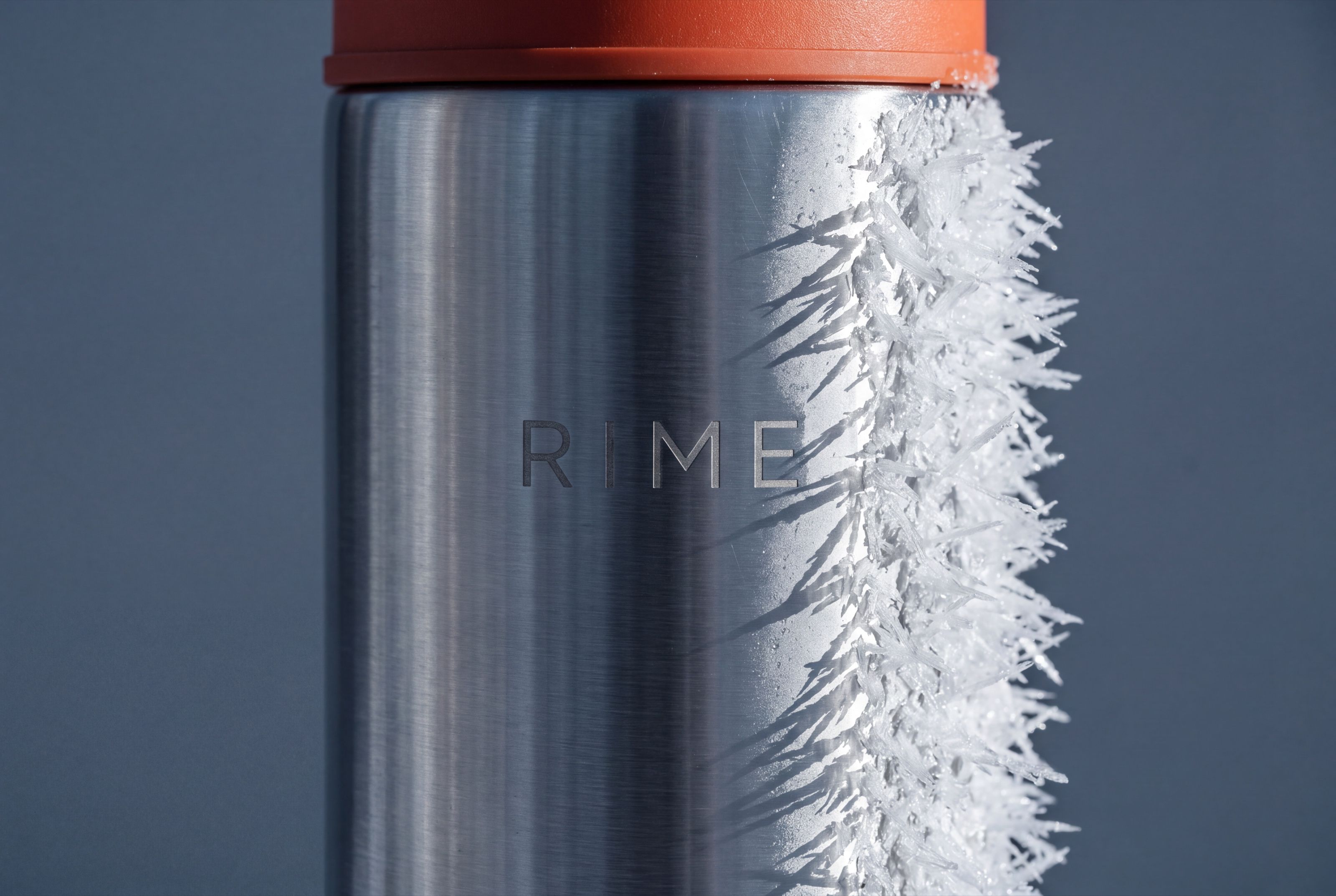 Macro of rime frost crystals growing across brushed steel